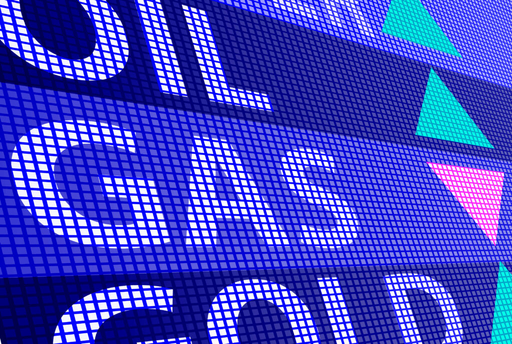 Blaues digitales Display mit den Wörtern „Oil“, „Gas“ und „Gold“. Bunte Pfeile zeigen nach oben und unten.